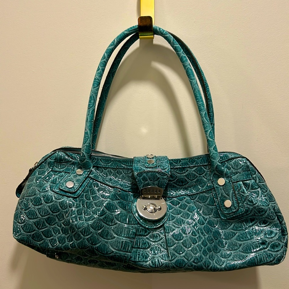 Guess brand sassy teal purse with magnetic closure and zippered pockets